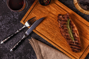 Beef steak on a dark background.