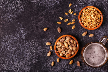 Beer and nuts on stone background.