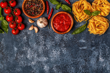 Italian food background with pasta, spices and vegetables.