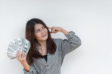 Happy business woman with a lot of dollar money in hand on white background