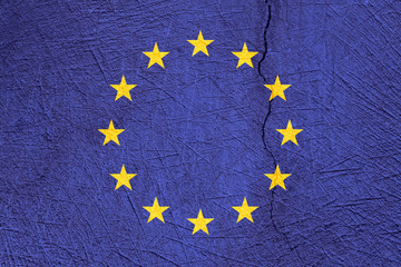 European Union flag on cracked texture background.