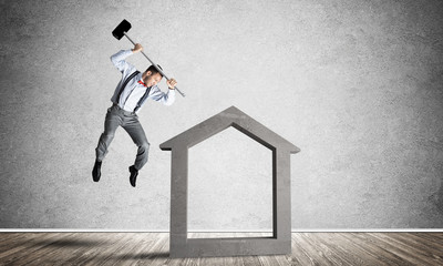 Stone home silhouette in empty room as symbol for real estae insurance