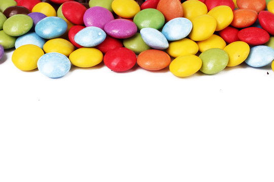 Chocolate candy candies background smarties on isolated white studio background. Closeup photo. Clipping path. Easy to use. White background. Cutout cut out. Smarties with text space.