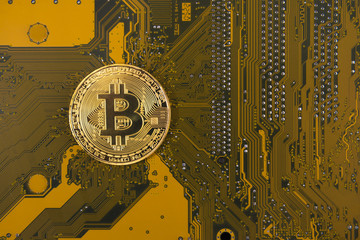 gold bitcoin concept - computer circuit board with bitcoin processor and microchips. Electronic currency, Internet finance