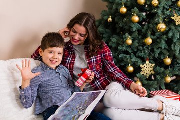 Family sitting by the Christmas tree