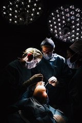 Doctors operating kneecap.