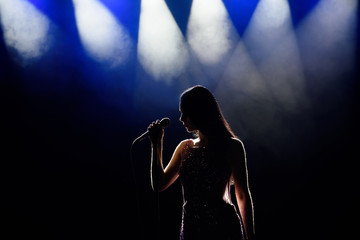 Fototapeta na wymiar Singer woman on stage