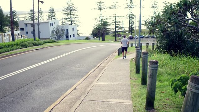 man running on sidewalk