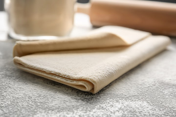 Fresh raw puff dough on table