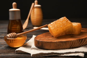 Fresh honeycombs and delicious honey on table