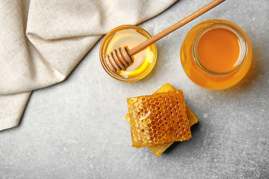 Delicious honey and fresh honeycombs on table, top view