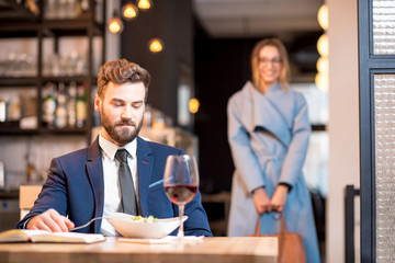 Businessman waiting for the woman walking back during a dinner at the restaurant