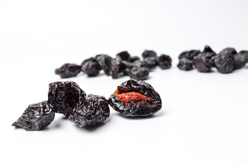 Dried plum fruits on white background