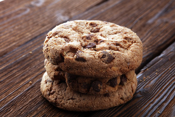 Chocolate cookies on wooden table. Chocolate chip cookies.