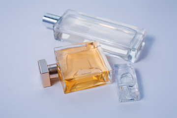 Three bottles of perfumes over grey