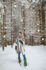 Fototapeta na wymiar Happy young woman walking in winter forest. Happy girl having fun in the snow. Snow covered trees. Snowy pine trees on a winter landscape. snovy trees on winter mountains