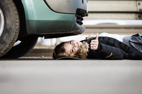 Woman, Repairing Broken Car Lying Under It