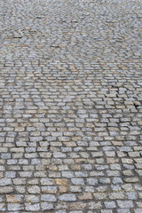 Old wet cobblestone. Paved street.