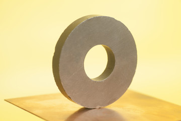 Round magnet on a yellow background