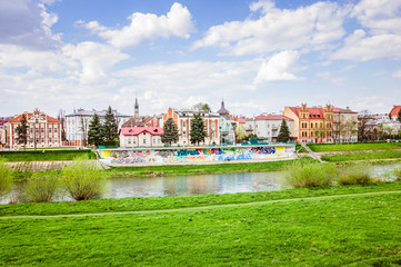 Beautiful river view and ancient buildings under white clouds and blue sky - obrazy, fototapety, plakaty