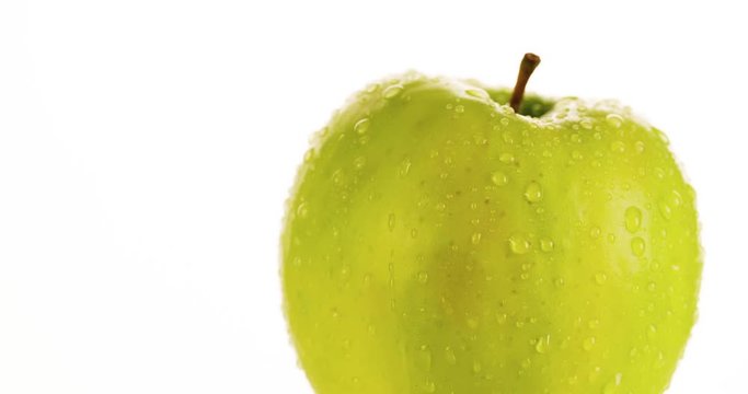 Fresh Green Apple Skin Texture Close Up Scene With Water Droplet Flowing Down On White Background. Natural Organic Healthy Food 4K Video