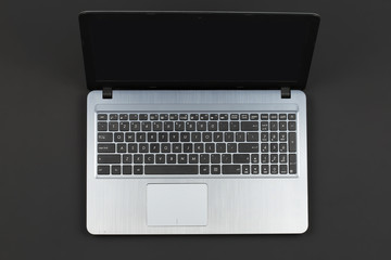 Disabled laptop on a gray surface top view
