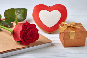 Valentine's Day. Red heart with red rose. notebook and gift box on a white background.
