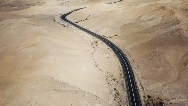 Desert road - Aerial footage of a new two lane road surrounded by dry desert landscape