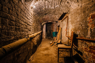 Fototapeta na wymiar Underground vaulted cellar of red brick under old mansion