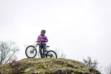 Cyclist descends from the mountain on a mountain bike, free space for your text.