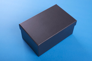 Black shoe box on blue background.