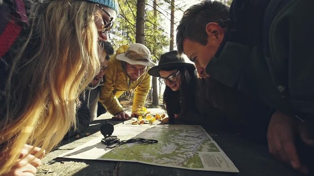 Cheerful travelers exploring map together