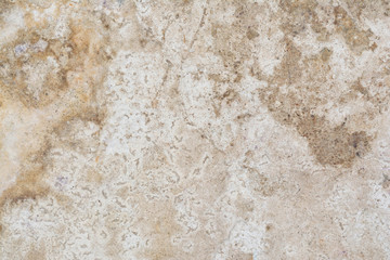 texture of the surface of an old antique wall with a plaster layer destroyed from moisture, a lot of cracks, blisters on the wall