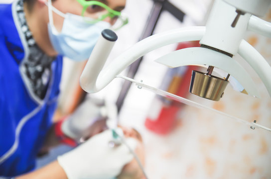 Close up of selective focus of Dentist's medical equipment with a dentist working in a blurred background