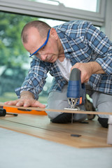 worker wood cutting flooring