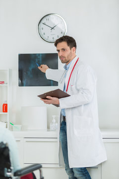 handsome young doctor at work in his office