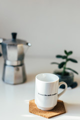Coffee maker and coffee in mug