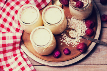 Jars with yogurt, raspberries and oat flakes 