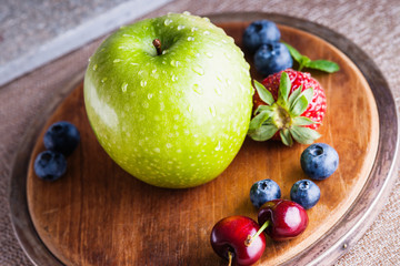 Fresh fruits on a wooden cutting board 