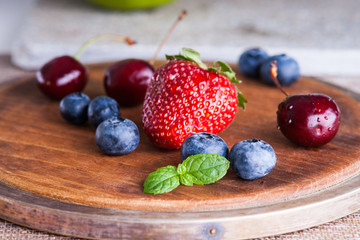 Fresh berries on a wooden cutting board 