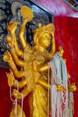 Statue of the multi-armed goddess in thailand temple