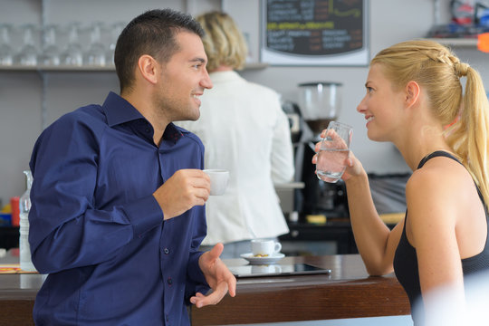 young couple drinking coffee at local cafe