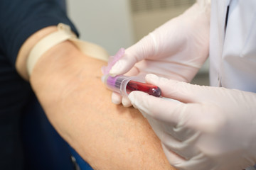 closeup of blood being taken from vein into vial