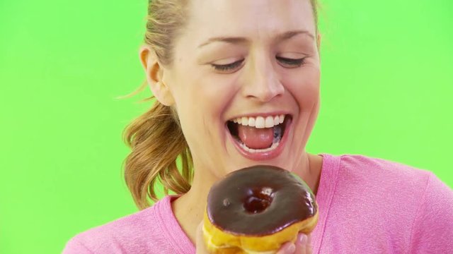 Close up of a woman eating a donut