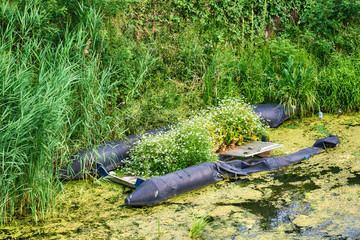 Naklejka premium damaged rubber boat with flowers