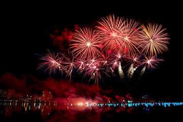 Beautiful fireworks on the water in the night sky