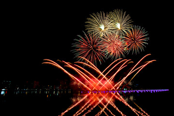 Beautiful fireworks on the water in the night sky