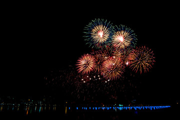 Beautiful fireworks on the water in the night sky
