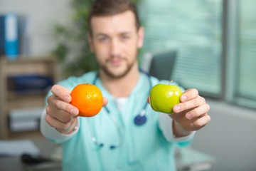 unknown medic or doctor holding apple and orange