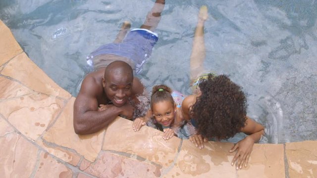 Portrait of African American family in swimming pool